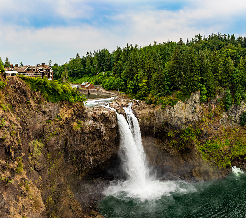 Panorama of Snoqualmie Falls with Power Station and Snoqualmie Lodge During the Day in Summer.
